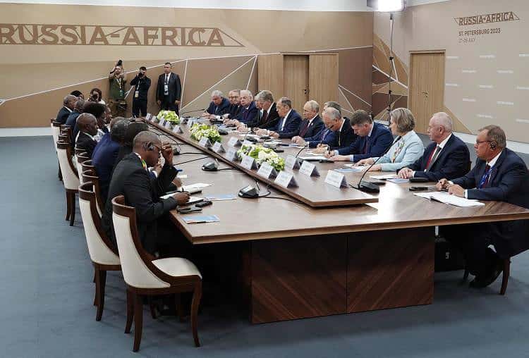 This pool image distributed by Sputnik agency shows Russian President Vladimir Putin meeting his Mozambique counterpart Filipe Jacinto Nyusi during the second Russia-Africa summit in Saint Petersburg on July 27, 2023. (Photo by Alexey DANICHEV / POOL / AFP)