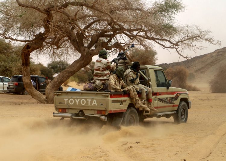 Niger soldiers patrol in the desert of Iferouane on February 12, 2020 to protect tourists and dignitaries during the Air Festival. (Photo by Souleymane Ag Anara / AFP)