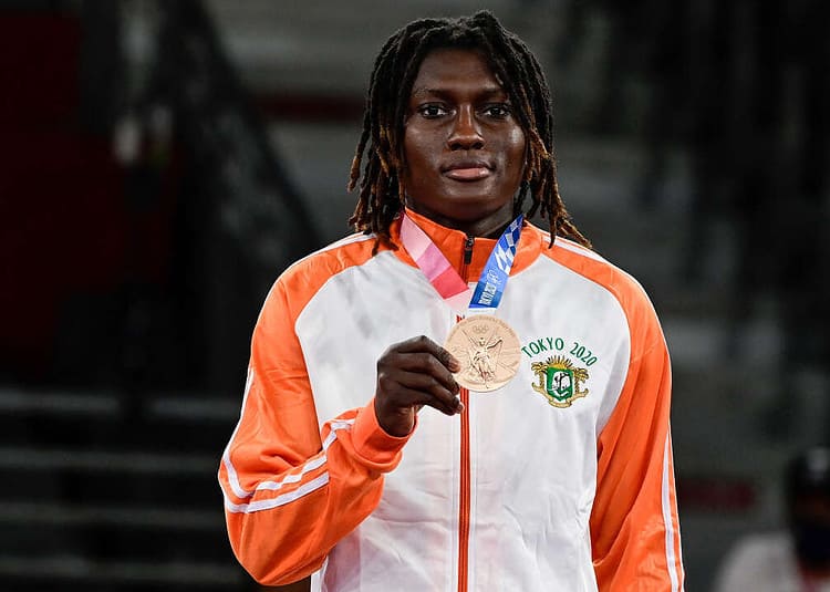 Bronze medalist Ivory Coast's Ruth Gbagbi poses on the podium after the taekwondo women's -67kg medal bouts during the Tokyo 2020 Olympic Games at the Makuhari Messe Hall in Tokyo on July 26, 2021. (Photo by Javier SORIANO / AFP)