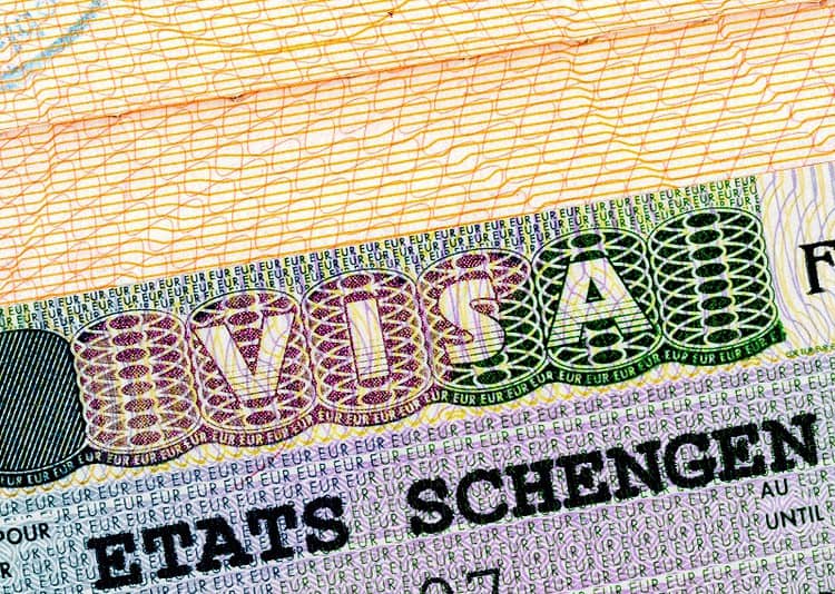 Schengen visa in passport closeup.