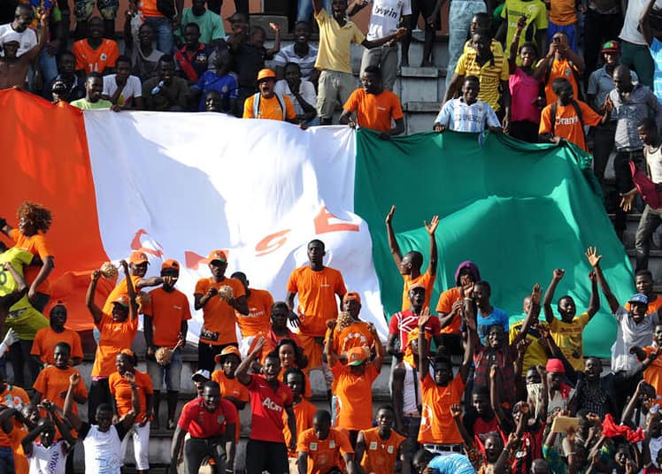 Ivory Coast's supporters celebrate after Ivory Coast scored during a African Cup of Nations 2015 qualifying football match Ivory Coast vs Sierra Leone on November 14, 2014 at the Houphouet Boigny stadium in Abidjan. AFP PHOTO / SIA KAMBOU