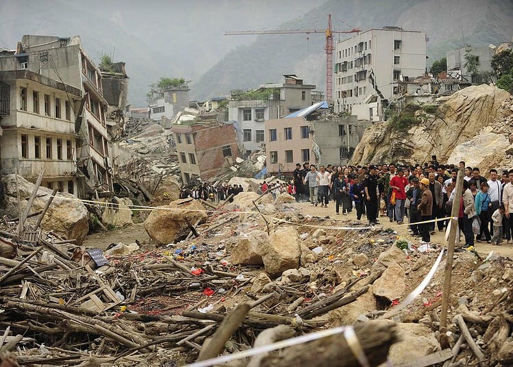 Thousands of people flock to look at the devastated town of Beichuan on May 12, 2009 which was destroyed in the May 12, 2008 Sichuan earthquake. Authorities had largely kept Beichuan town under lock and key due to the vast destruction wreaked by the earthquake, but ahead on the first anniversary they allowed former residents and visitors to re-enter and mourn their dead. TOPSHOTS/AFP PHOTO / Peter PARKS TOPSHOTS-CHINA-QUAKE