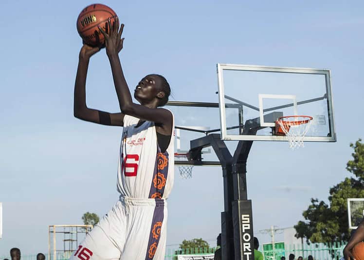 British professional basketball player and National Basketball Association (NBA) star Luol Deng (R) trains young players at Manute Bol basketball court on August 2, 2019 in Juba. - Luol Deng came to visit his family and to train South Sudanese basketball players after building a basketball court named Manute Bol in honour of late Sudanese-born American basketball player who died in 2010. (Photo by Akuot Chol / AFP)