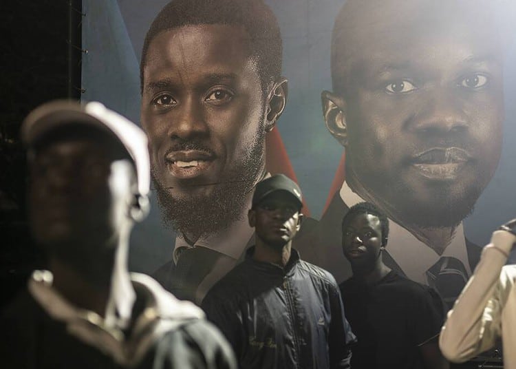 Supporters of presidential candidate Bassirou Diomaye Faye and Senegal's top opposition leader, Ousmane Sonko, gather outside their campaign headquarters as they await the results of the presidential election, in Dakar, Senegal, Sunday, March 24, 2024. (AP Photo/Mosa'ab Elshamy)
