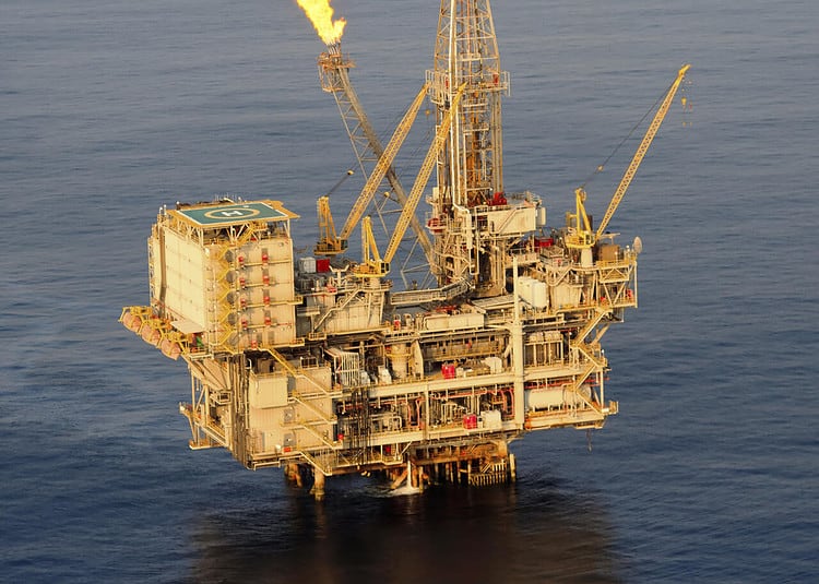 Close up aerial photograph of a fixed drilling platform oil rig.