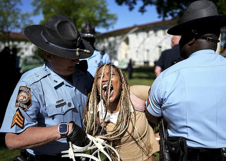 Georgia State Patrol officers detain a demonstrator on the campus of Emory University during a pro-Palestinian demonstration, Thursday, April 25, 2024, in Atlanta. (AP Photo/Mike Stewart)