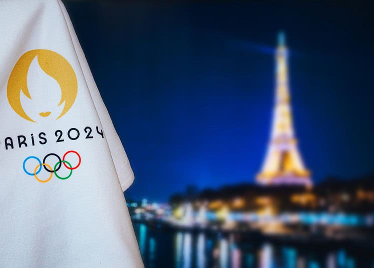 PARIS, FRANCE, AUGUST 8. 2022: Summer olympic game Paris 2024 black background. Official logo of SOG 2024 in Paris on white blanket with dark City in night. Black edit space, sport event