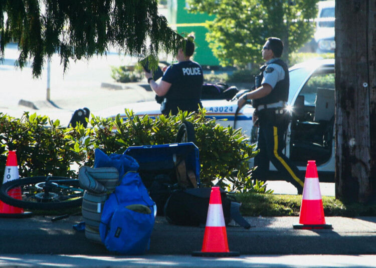 Police officers work at the site after authorities alerted residents of multiple shootings targeting transient victims in the Vancouver suburb of Langley, British Columbia, Canada July 25, 2022. REUTERS/Jesse Winter