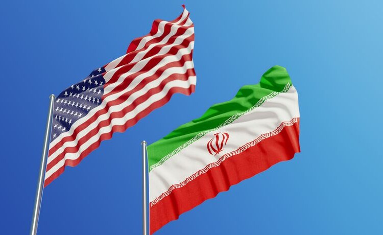 American and Iranian flags are waving with wind over blue sky. Low angle view. Dispute and conflict concept. Horizontal composition with copy space.