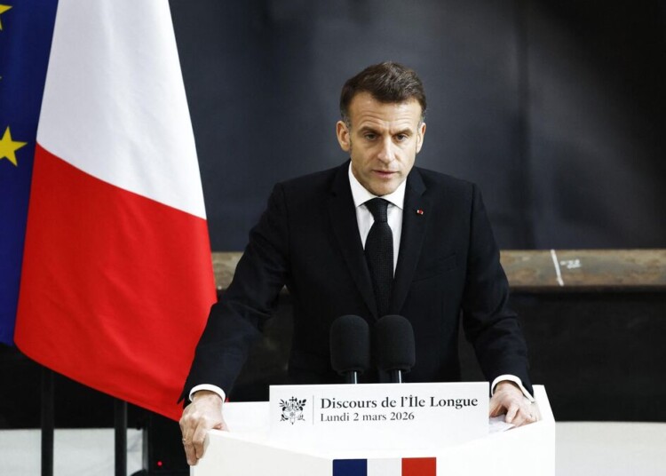 France's President Emmanuel Macron delivers a speech next to nuclear-powered ballistic missile submarine (SSBN) submarine "Le Temeraire" - S617 during his visit to the Nuclear Submarine Navy Base of Ile Longue in Crozon, north-western France on March 2, 2026. High expectations, few certainties: on March 2, 2026, Emmanuel Macron is set to outline how France's nuclear deterrent can help strengthen security in Europe in the face of a increasingly brutal world and an increasingly uncertain US ally. This issue has been brought sharply into focus by the Israeli-US offensive in Iran this weekend, against the backdrop of the Iranian nuclear crisis, which is shaking the entire Middle East and, by extension, the international community. (Photo by Yoan VALAT / POOL / AFP)