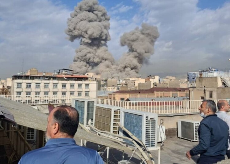 People watch as smoke rises on the skyline after an explosion in Tehran, Iran, Saturday, Feb. 28, 2026.(AP Photo)