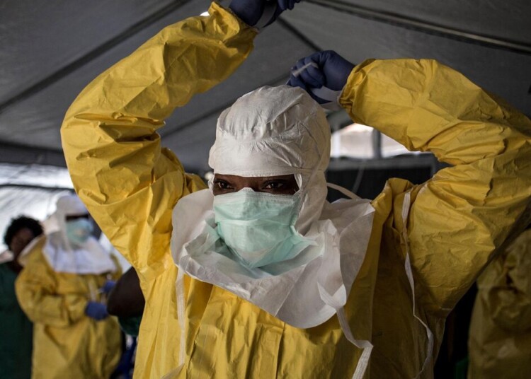(FILES) A medical worker puts on her Personal Protective Equipment (PPE) ahead of entering an Ebola Treatment Centre run by The Alliance for International Medical Action (ALIMA) on August 12, 2018, in Beni. An outbreak of the ebola virus has been blamed for dozens of deaths in the east of the Democratic Republic of the Congo, African health authorities said on May 15, 2026.
The outbreak is in Ituri province. (Photo by John WESSELS / AFP)