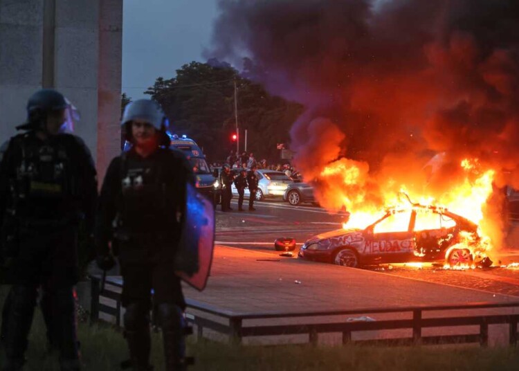 A car burns as PSG supporters celebrate in Paris, Saturday, May 30, 2026 after the Champions League final soccer match between Paris Saint-Germain and Arsenal that's being played in Budapest., PSG won the game. (AP Photo/Thomas Padilla)