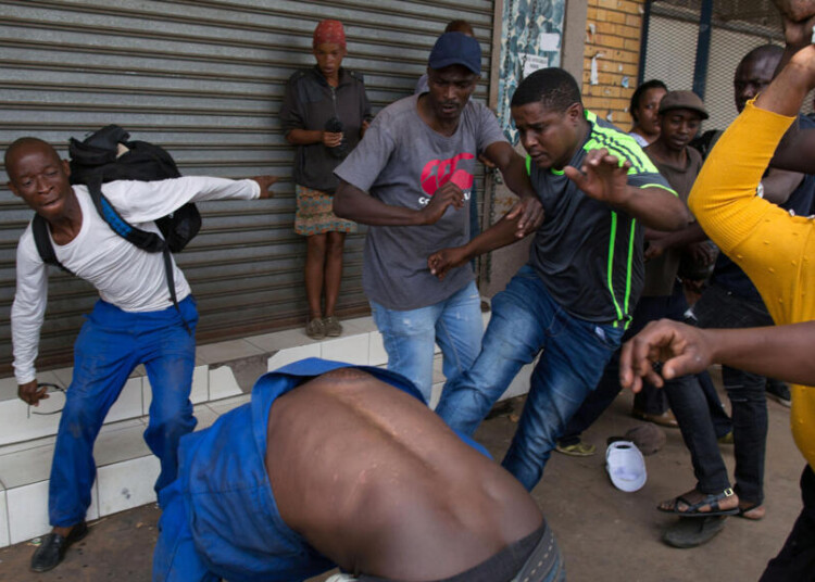 A vigilante mob attacks a Nigerian migrant outside a church in Pretoria, South Africa February 18, 2017. REUTERS/James Oatway FOR EDITORIAL USE ONLY. NO RESALES. NO ARCHIVES TPX IMAGES OF THE DAY